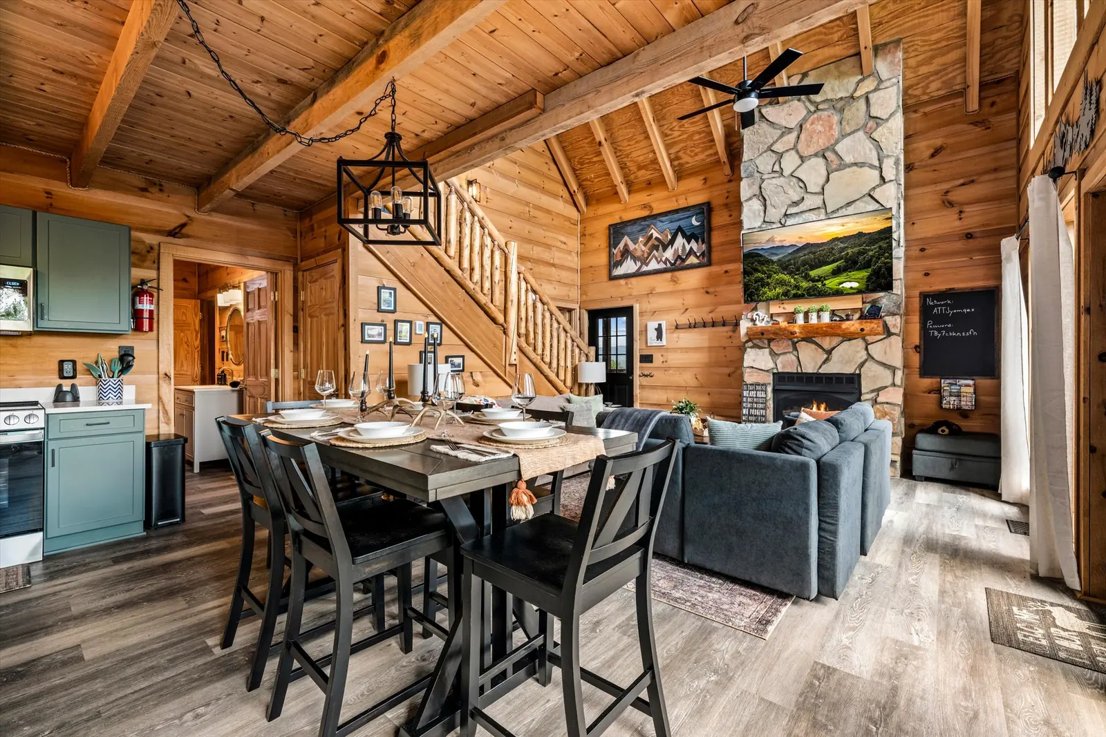 View across the dining table toward the kitchen and living area